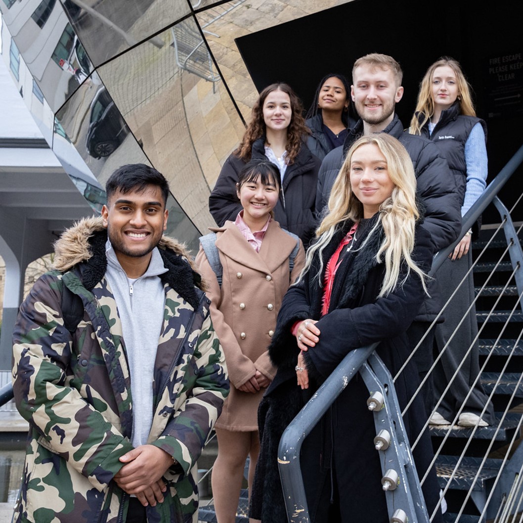 A photo of a group of law students by the silver planetarium building, next to a text banner saying "Discover the LLM in Law, Innovation and Technology. Unlock professional opportunities in one of the fastest developing legal fields."  